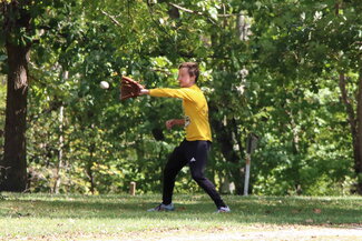 Student playing baseball