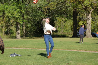 Student throwing football