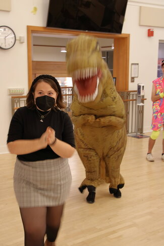 Student and student in dino costume