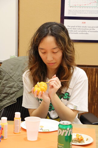 Student painting pumpkin