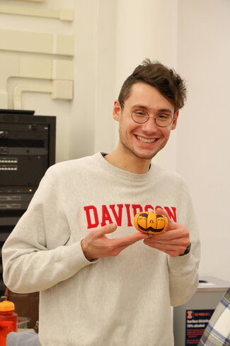 Student pictured with his painted pumpkin