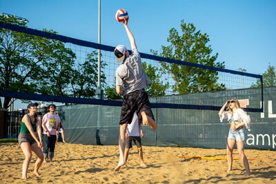 Students playing sand volleyball
