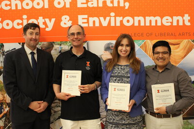 Professors posing with awards.