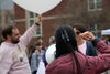 A student ready to launch a weather balloon as another talks into a megaphone.